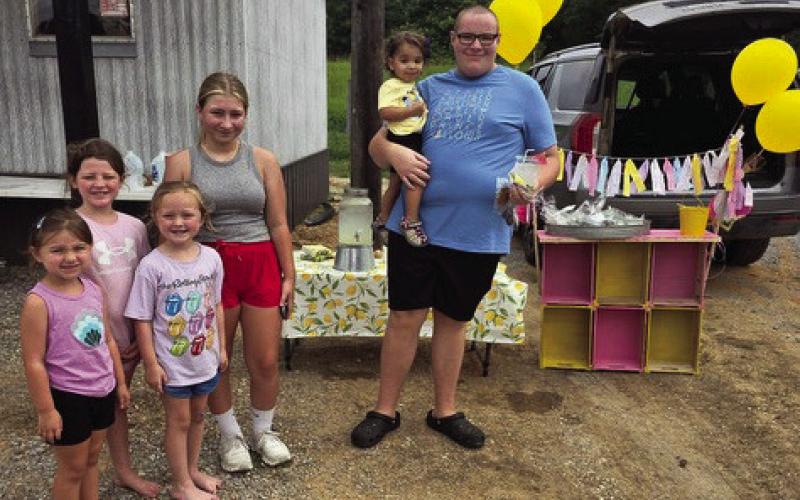 (LEFT to RIGHT) Emma Evans, Carolyne Barron, Jolie Taliaferro, Audrey Duck, and Kyle Watson (childhood cancer survivor). They raised $620 for St. Jude’s selling lemonade at Duck’s Barber Shop.