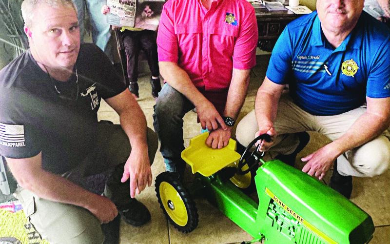 CPSO TOOTIE COOPER, (left) along with CPSO Sheriff Toney Edwards (center), and LPSO Joel Arnold at right, pictured here with restored family heirloom John Deere tractor.